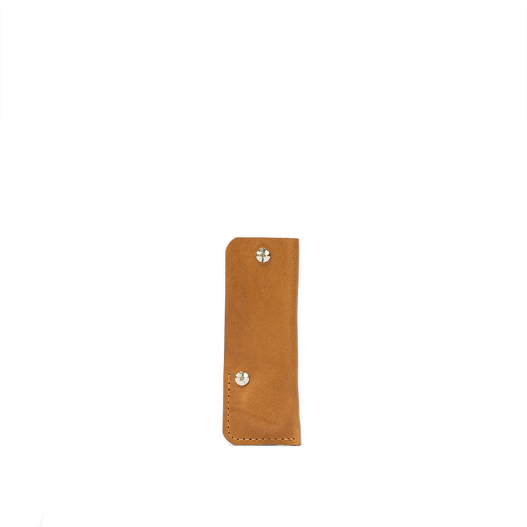 a brown leather case with silver screws