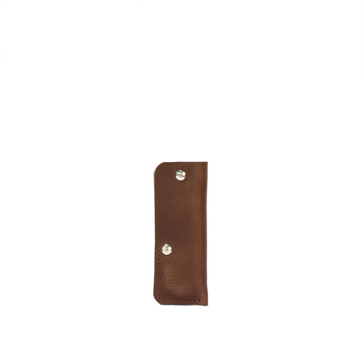 a brown leather case with silver rivets