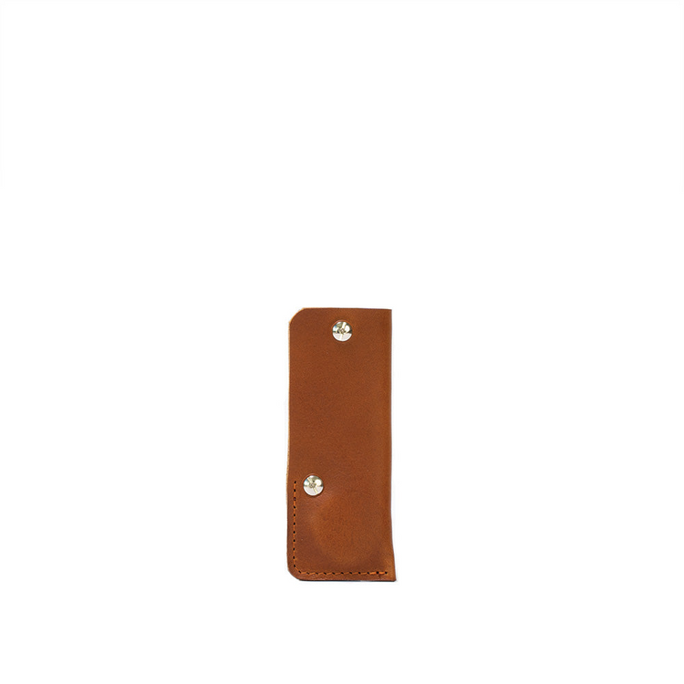 a brown leather case with silver rivets