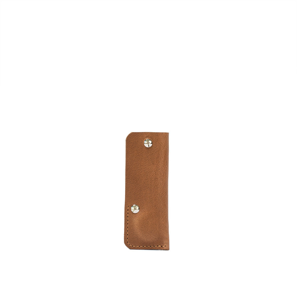 a brown leather case with silver rivets