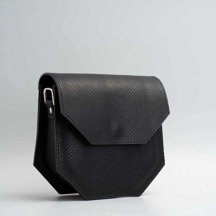 a black leather bag with a silver handle
