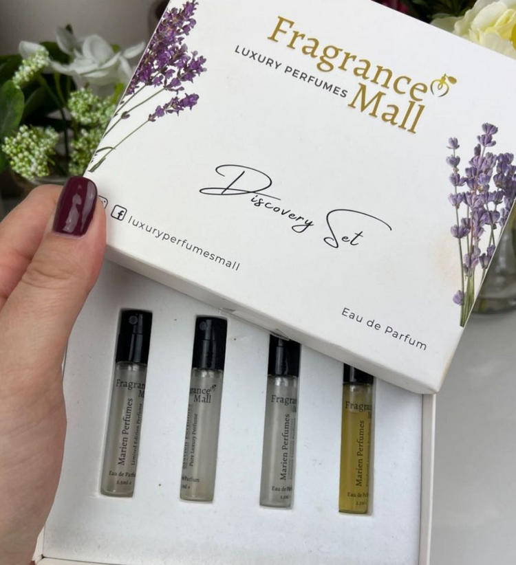 a hand holding a box with perfume bottles