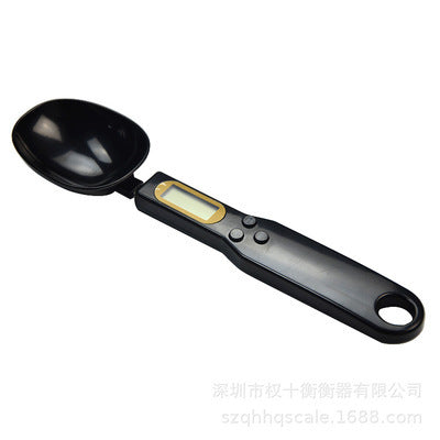a black measuring spoon with a digital display
