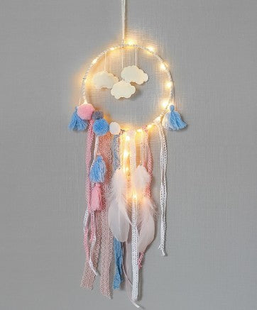 a dream catcher with lights and clouds