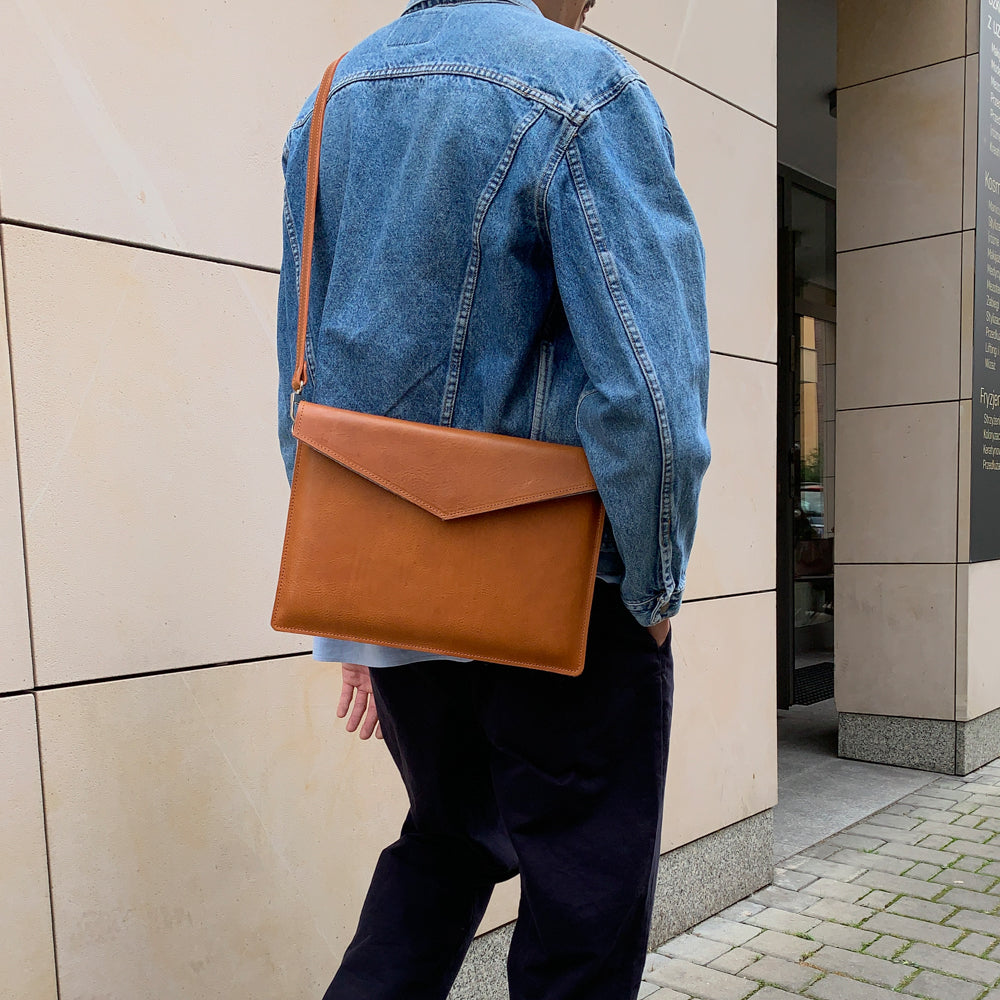 a man wearing a denim jacket and black pants