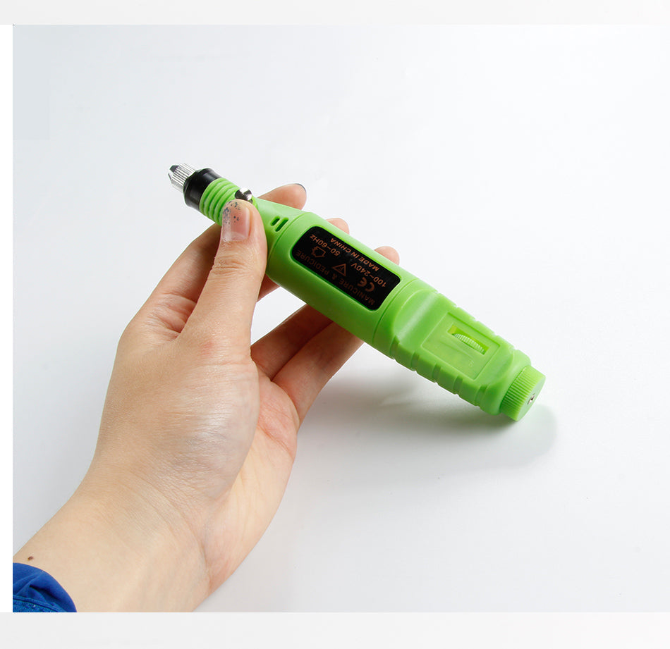 a hand holding a green device