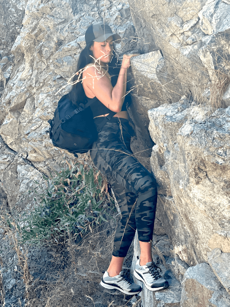 a woman climbing a rock