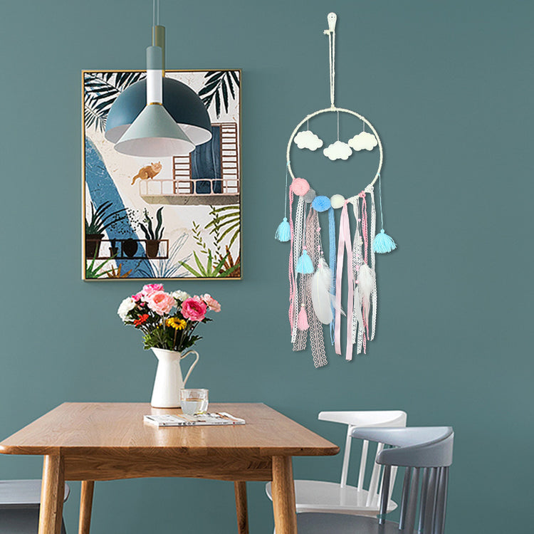 a table with a vase of flowers and a dream catcher