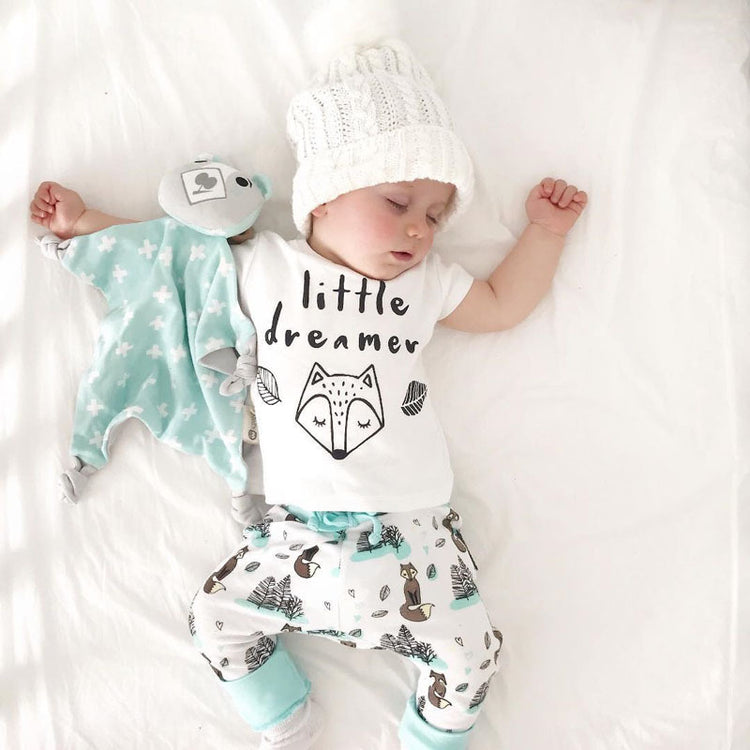 a baby sleeping on a bed