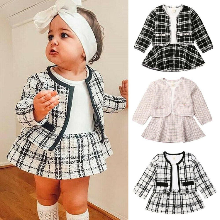 a baby girl wearing a dress
