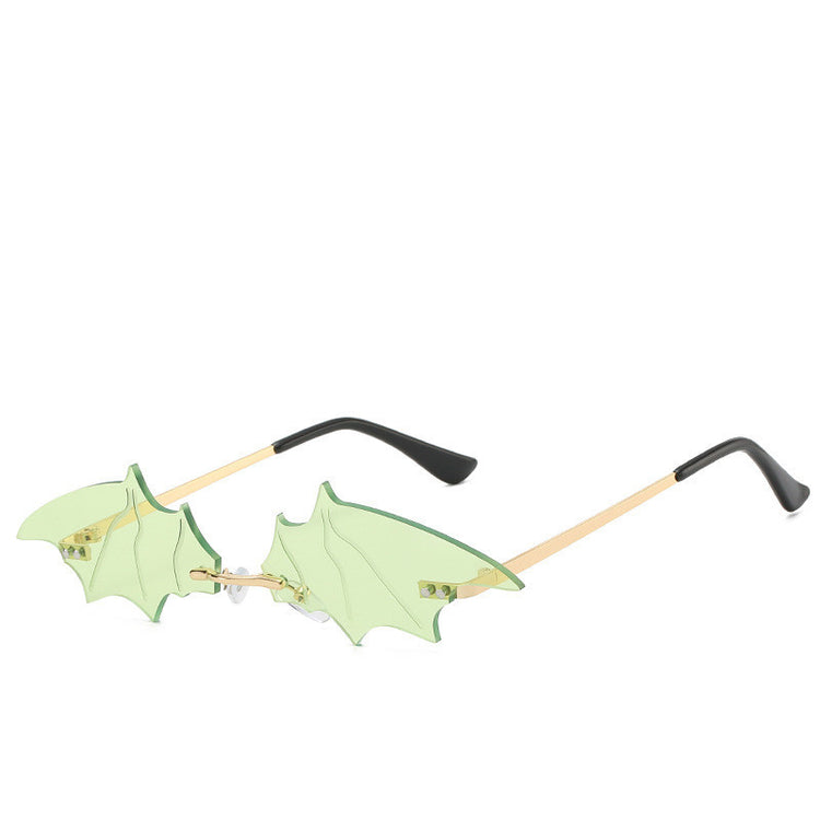 a pair of sunglasses with green wings