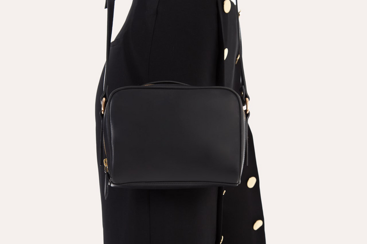 a person wearing a black dress and a black purse