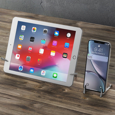 a tablet and a cell phone on a table