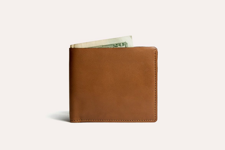 a brown wallet with money in it
