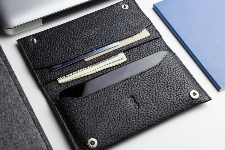 a black leather wallet with a phone inside