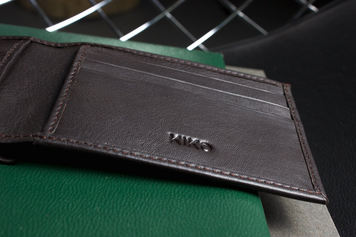 a wallet on a green surface
