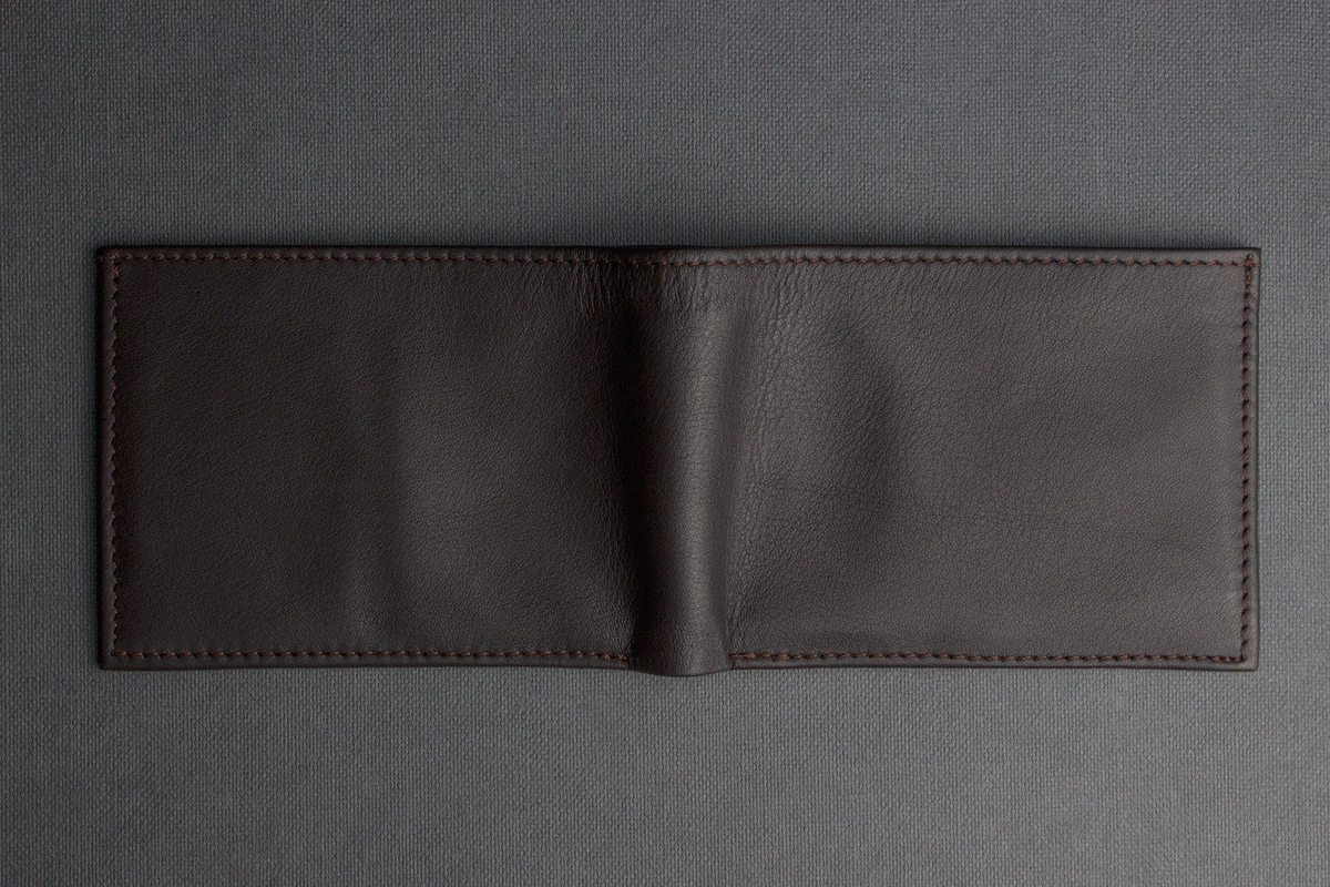a black leather wallet on a gray surface