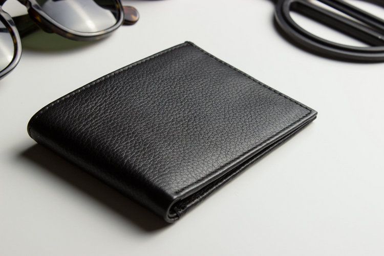 a wallet and sunglasses on a table