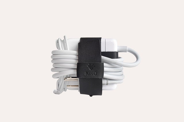 a white charger wrapped in a black strap