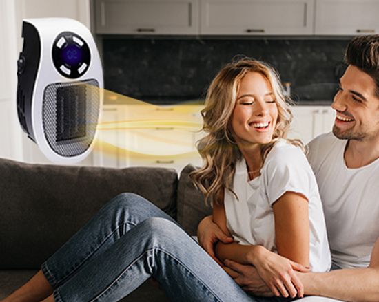 a man and woman sitting on a couch with a fan