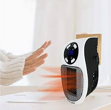 a hand reaching out to a heater