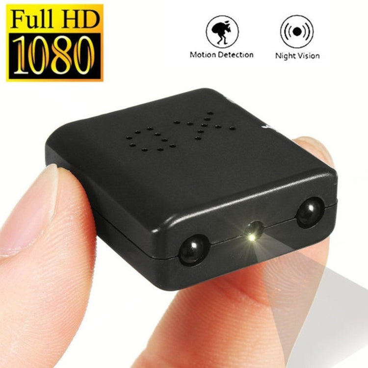 a hand holding a small black object