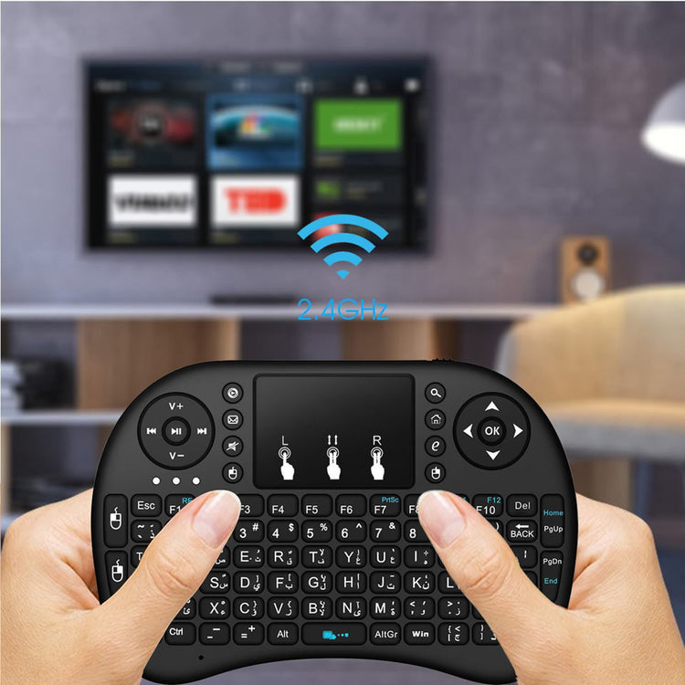 a hand holding a small black keyboard