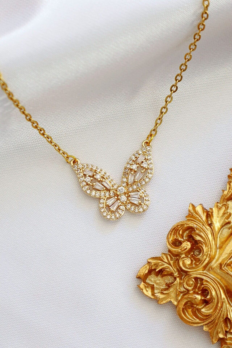 a gold butterfly necklace with diamonds