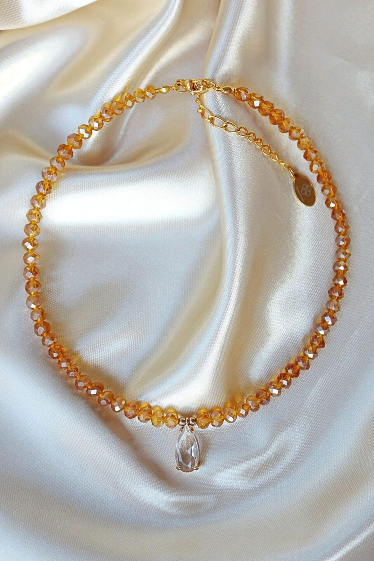 a necklace on a white fabric