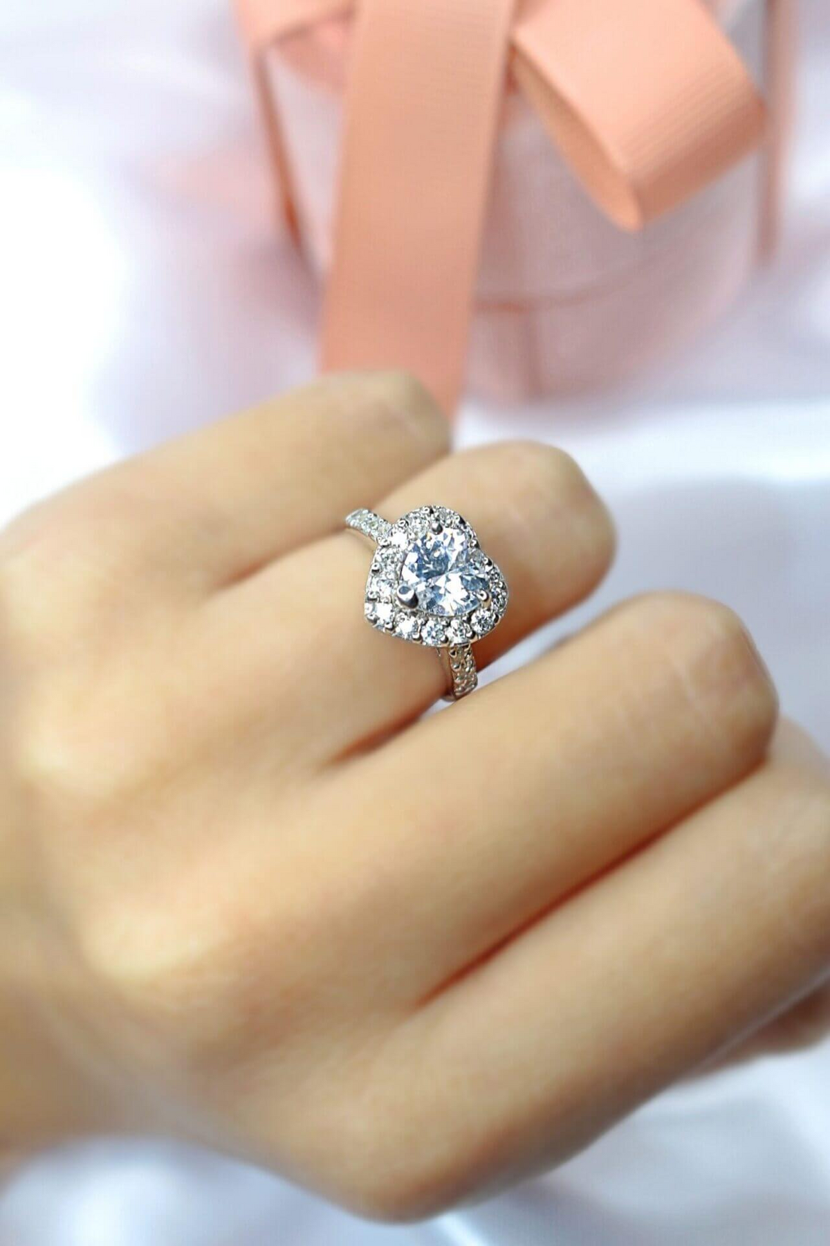 a hand with a diamond ring