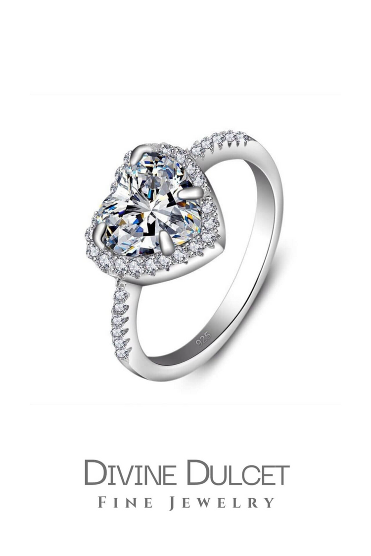 a diamond ring with a heart shaped stone