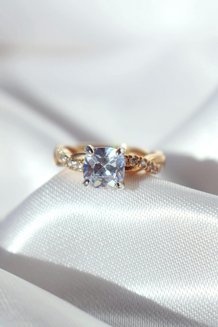 a gold ring with a square stone on it