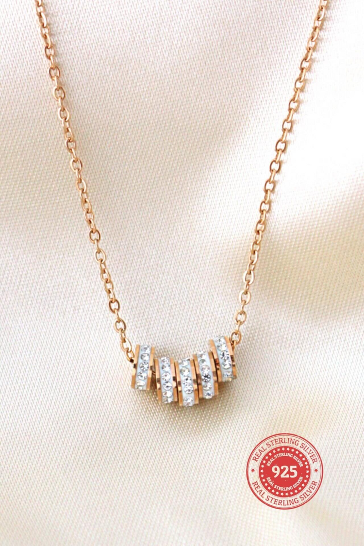 a gold necklace with diamonds on it