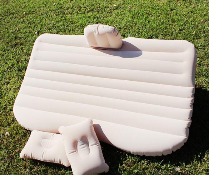 a mattress and pillows on grass