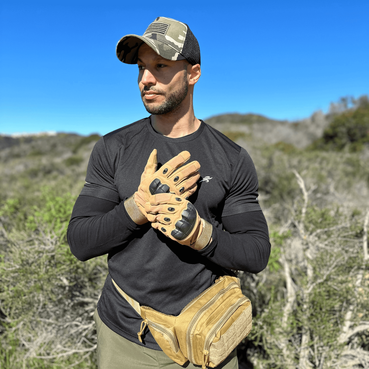 a man wearing baseball gloves and a baseball cap
