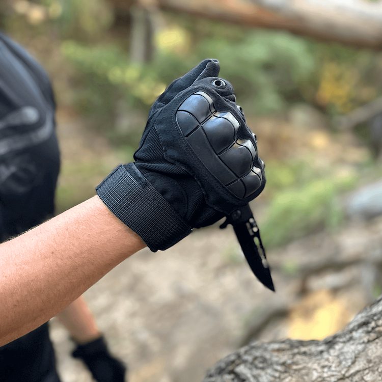 a person wearing gloves and holding a knife