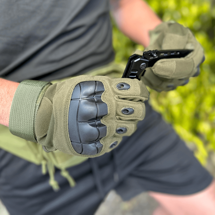 a person wearing gloves holding a phone