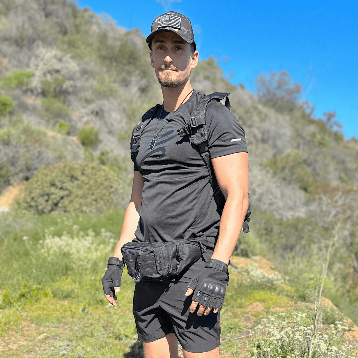 a man in a black shirt and shorts