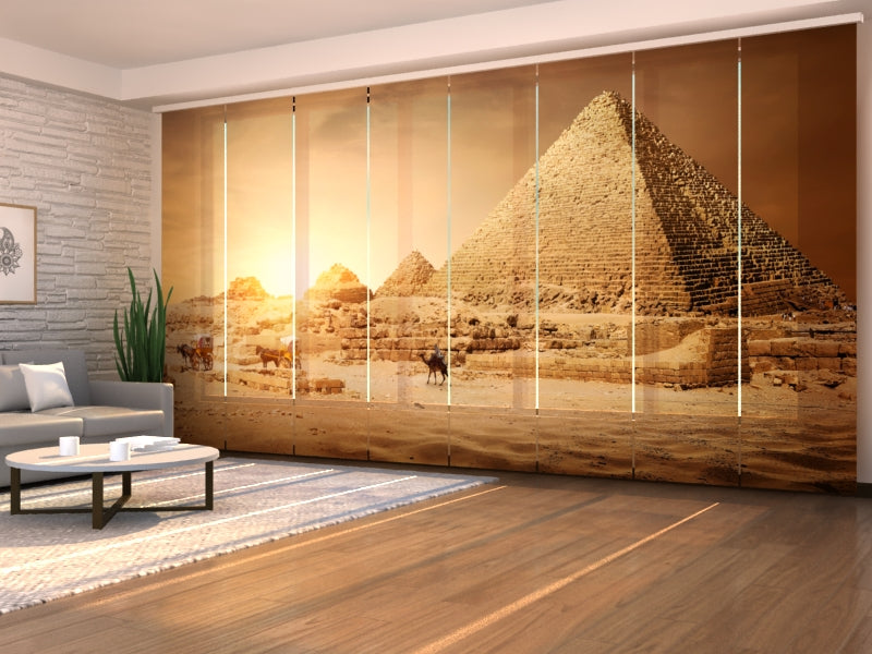 a room with a large window with a pyramids and a couch