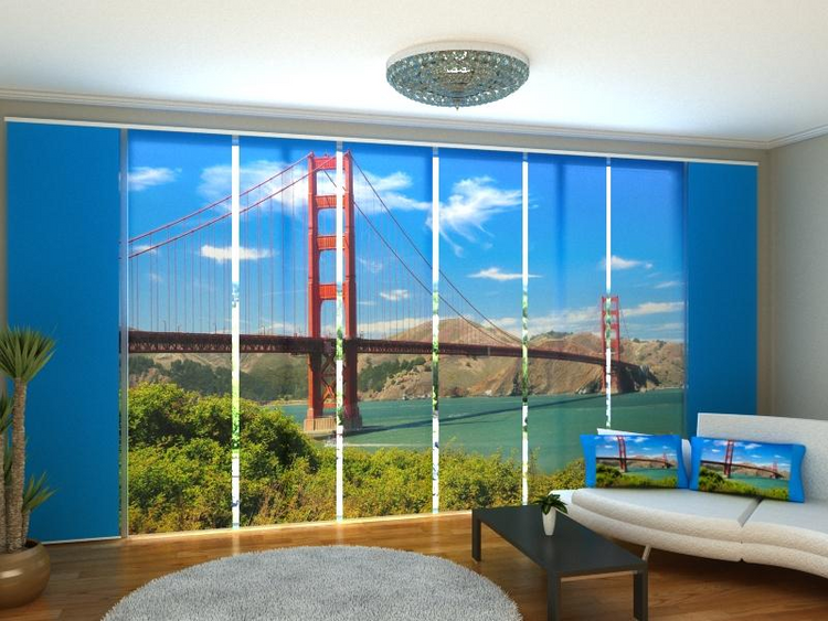 a room with a large window with a large bridge and a couch