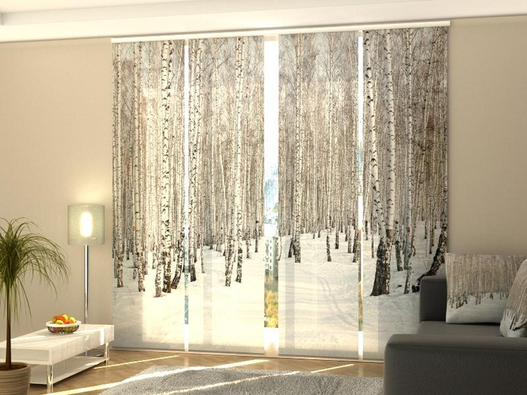 a room with a couch and a window with trees