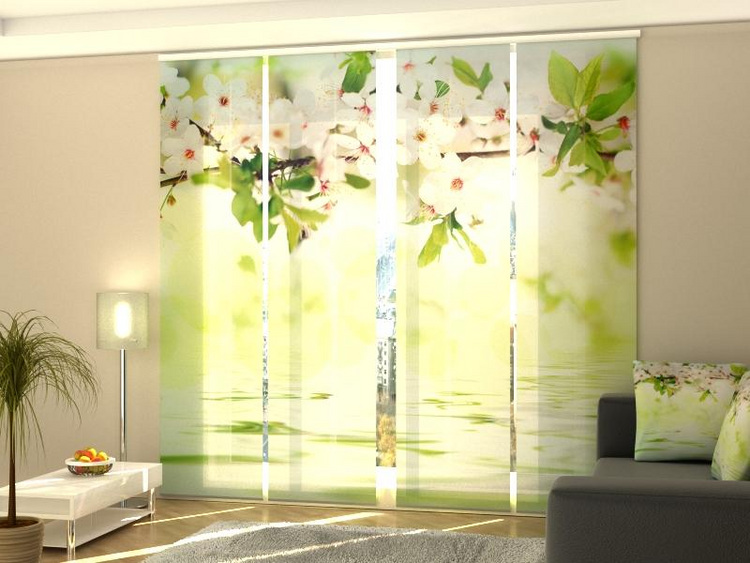 a room with a couch and a window with a picture of a tree