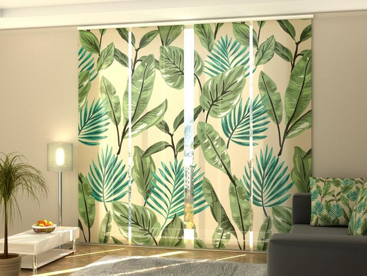 a room with a couch and a window with a floral curtain