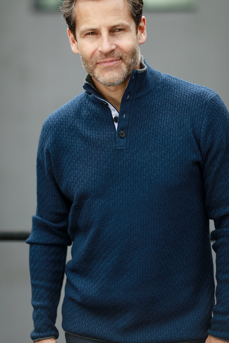 a man in a blue sweater