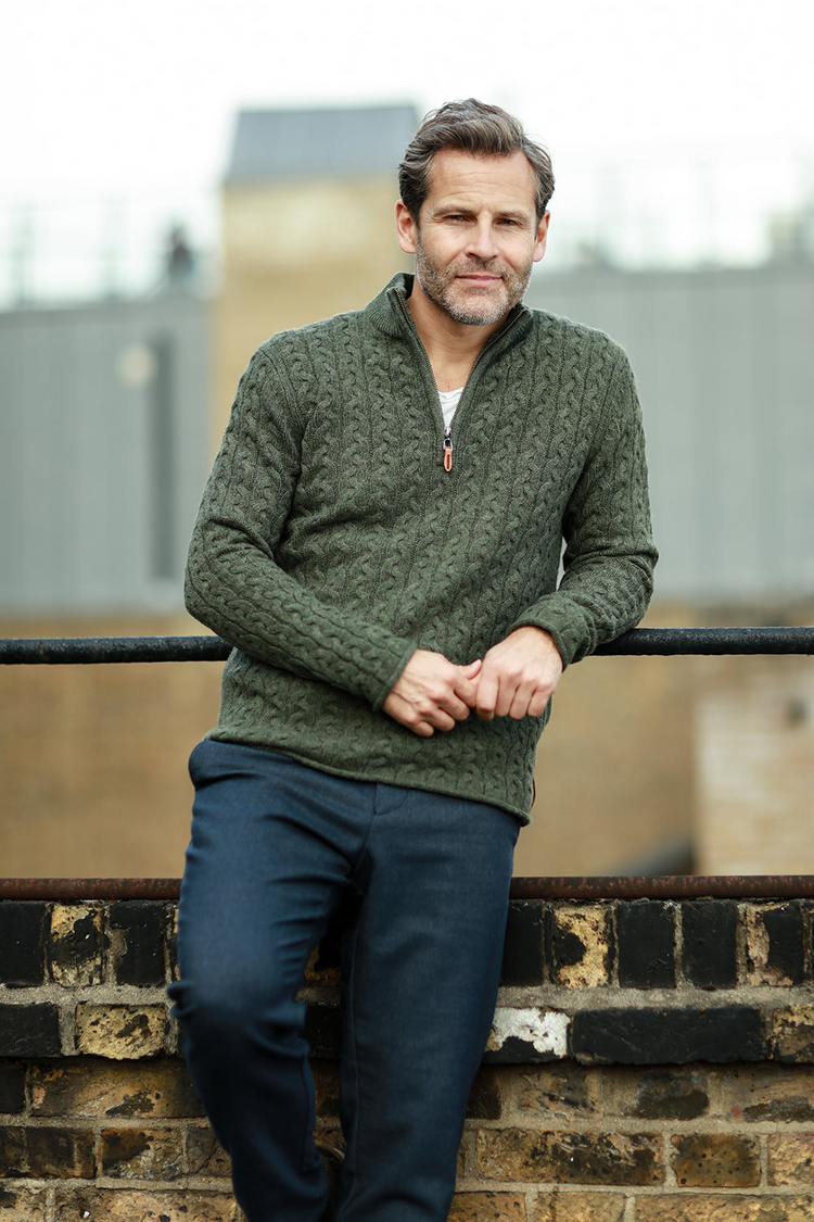 a man leaning against a railing