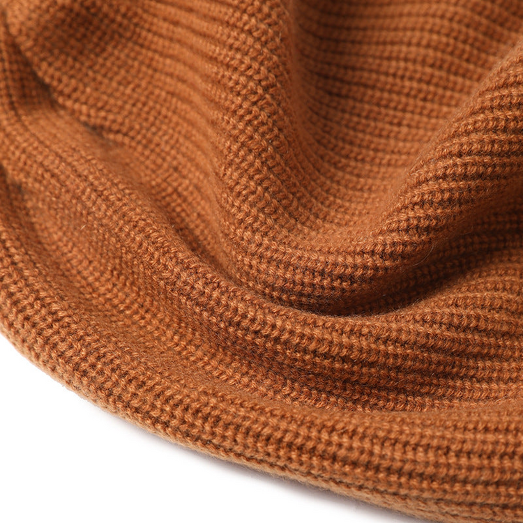 a close up of a brown knitted hat
