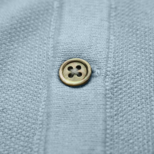 a button on a blue shirt