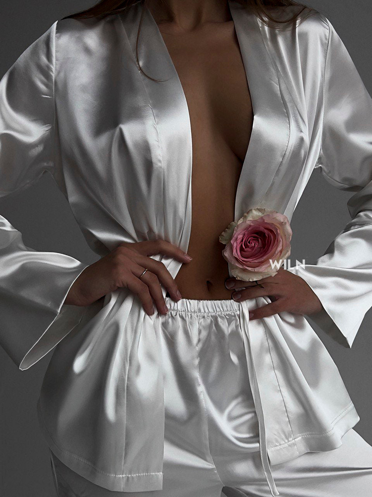 a woman wearing a white robe and shorts