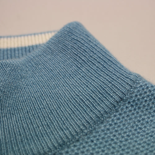 a close up of a blue sweater