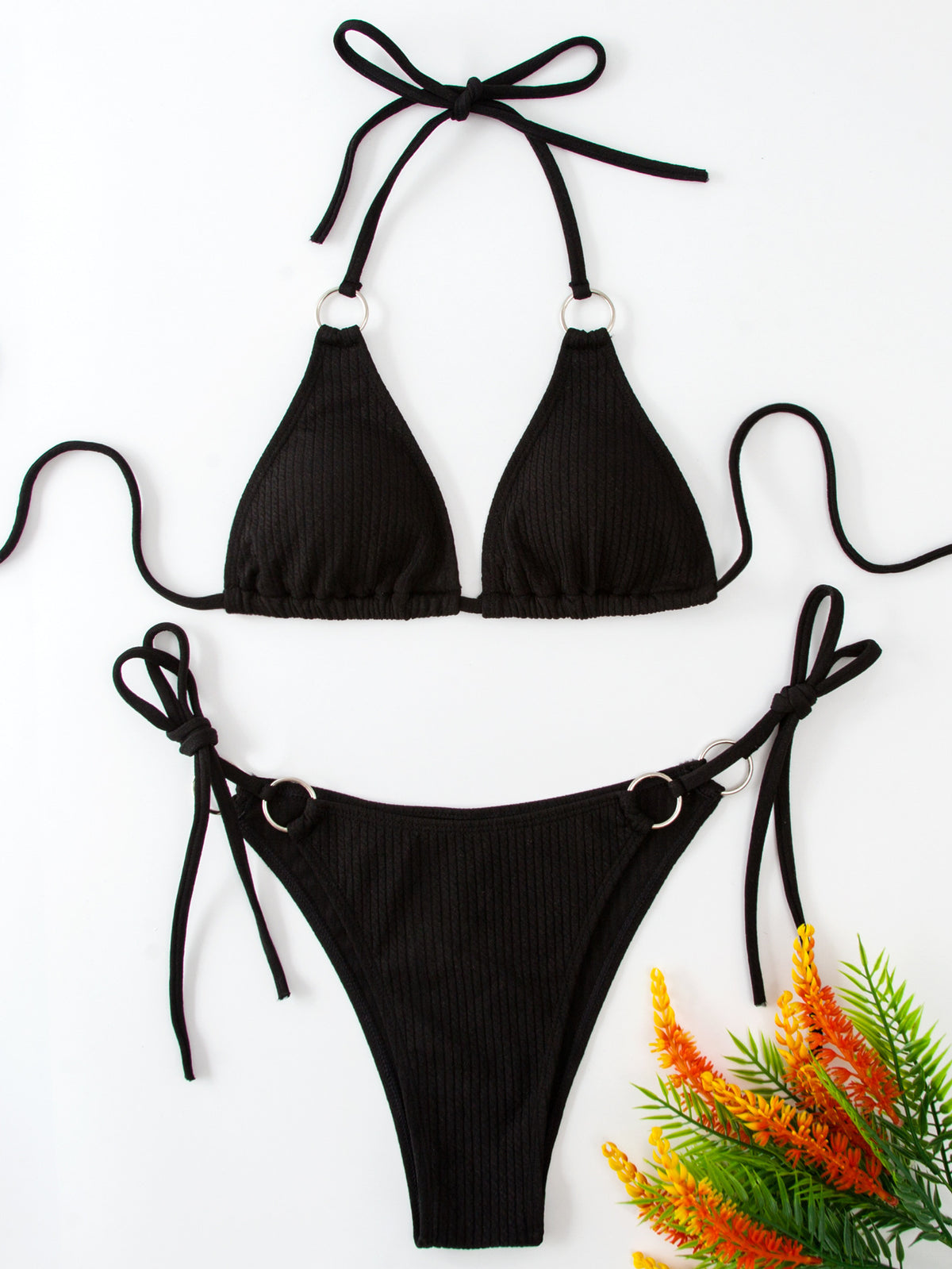 a black garment with straps and a bunch of flowers